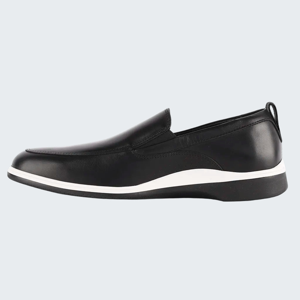 Black slip-on shoe with a white sole on a white background