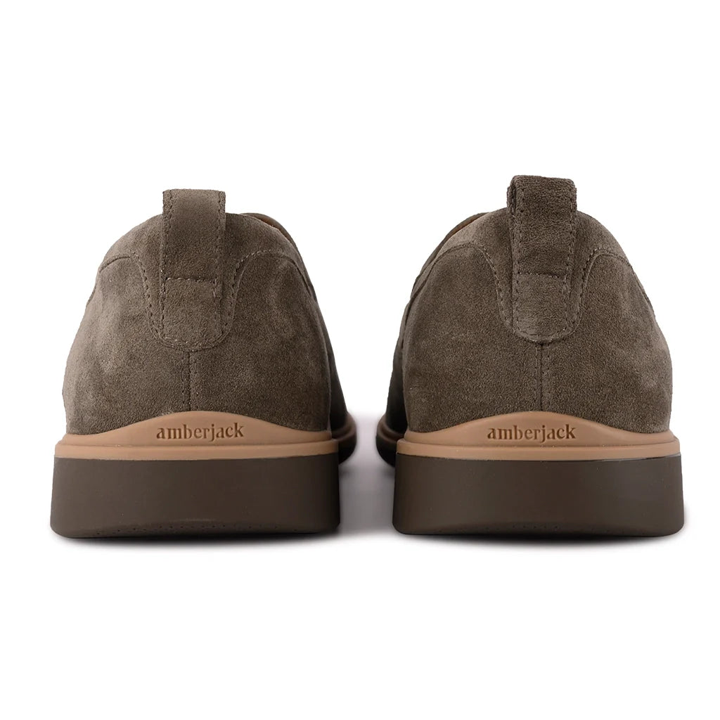 Brown suede shoes with 'amberjack' branding on a white background