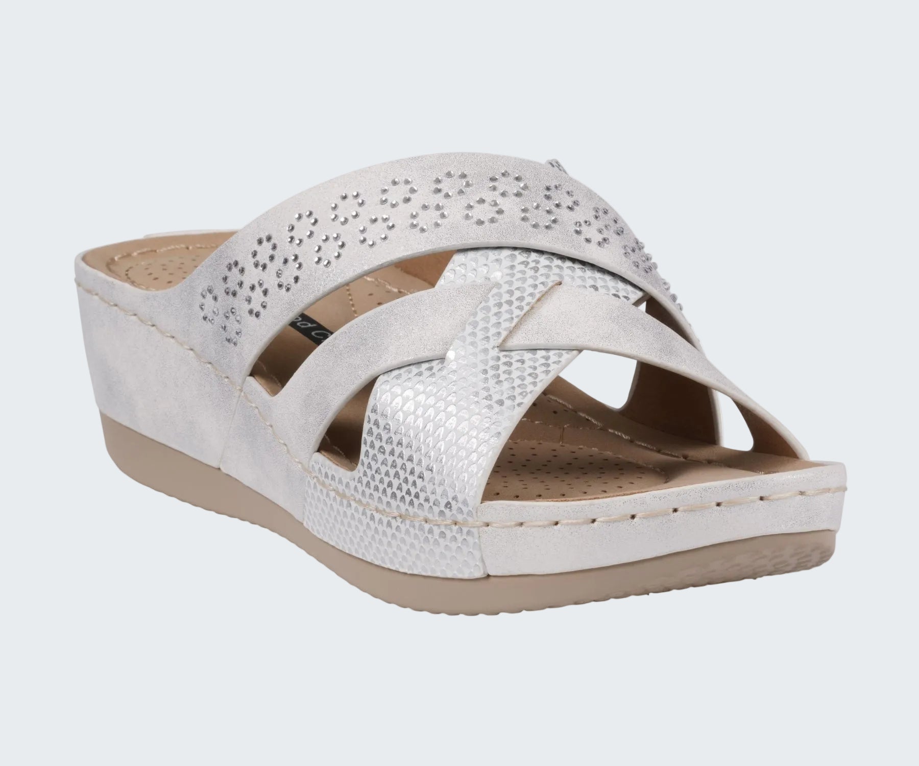 White wedge sandal with a strap on a white background
