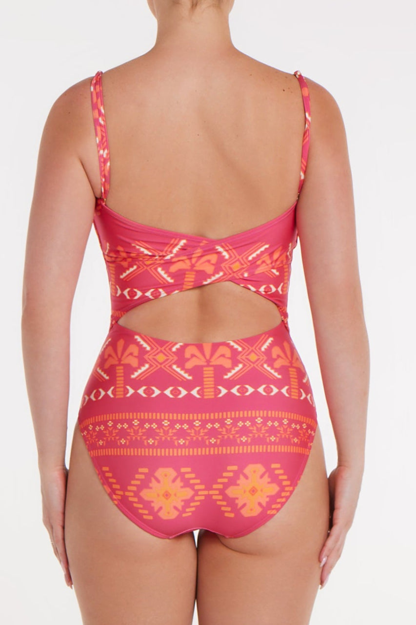 Pink patterned swimsuit with cutout design on a white background