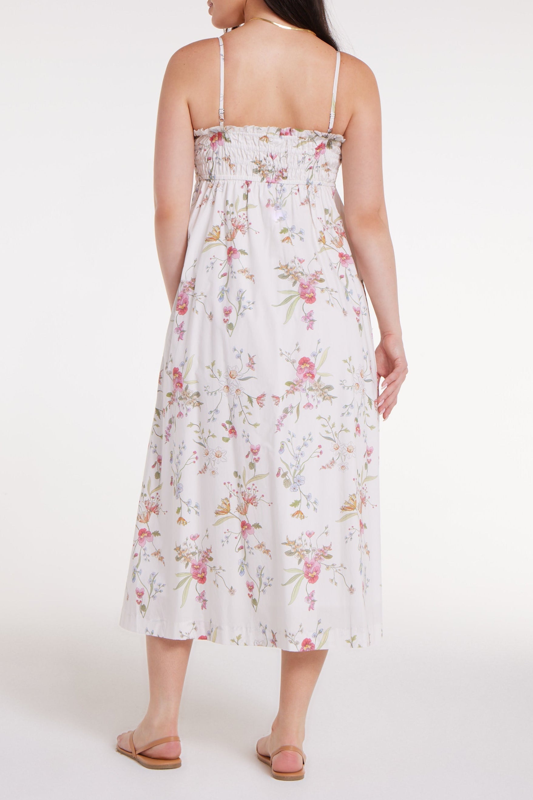 Woman wearing a floral dress on a white background