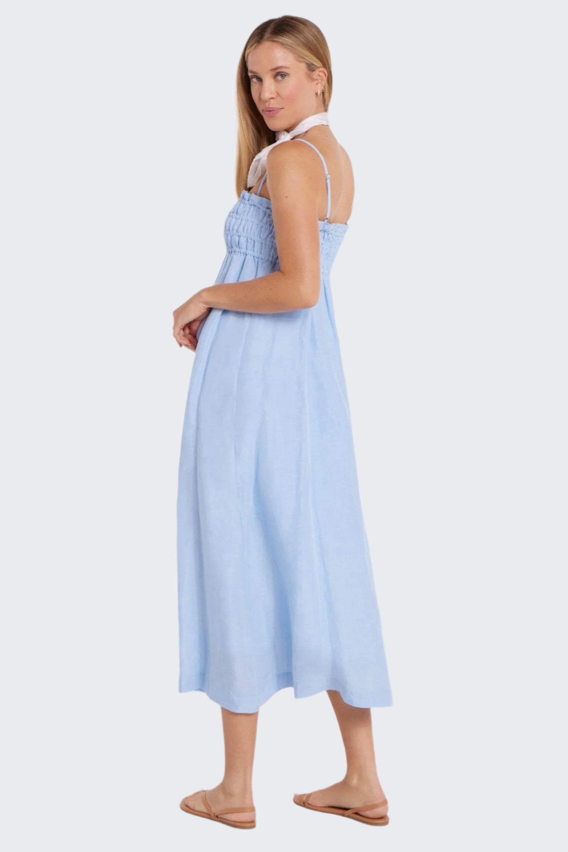 Woman wearing a light blue dress on a white background