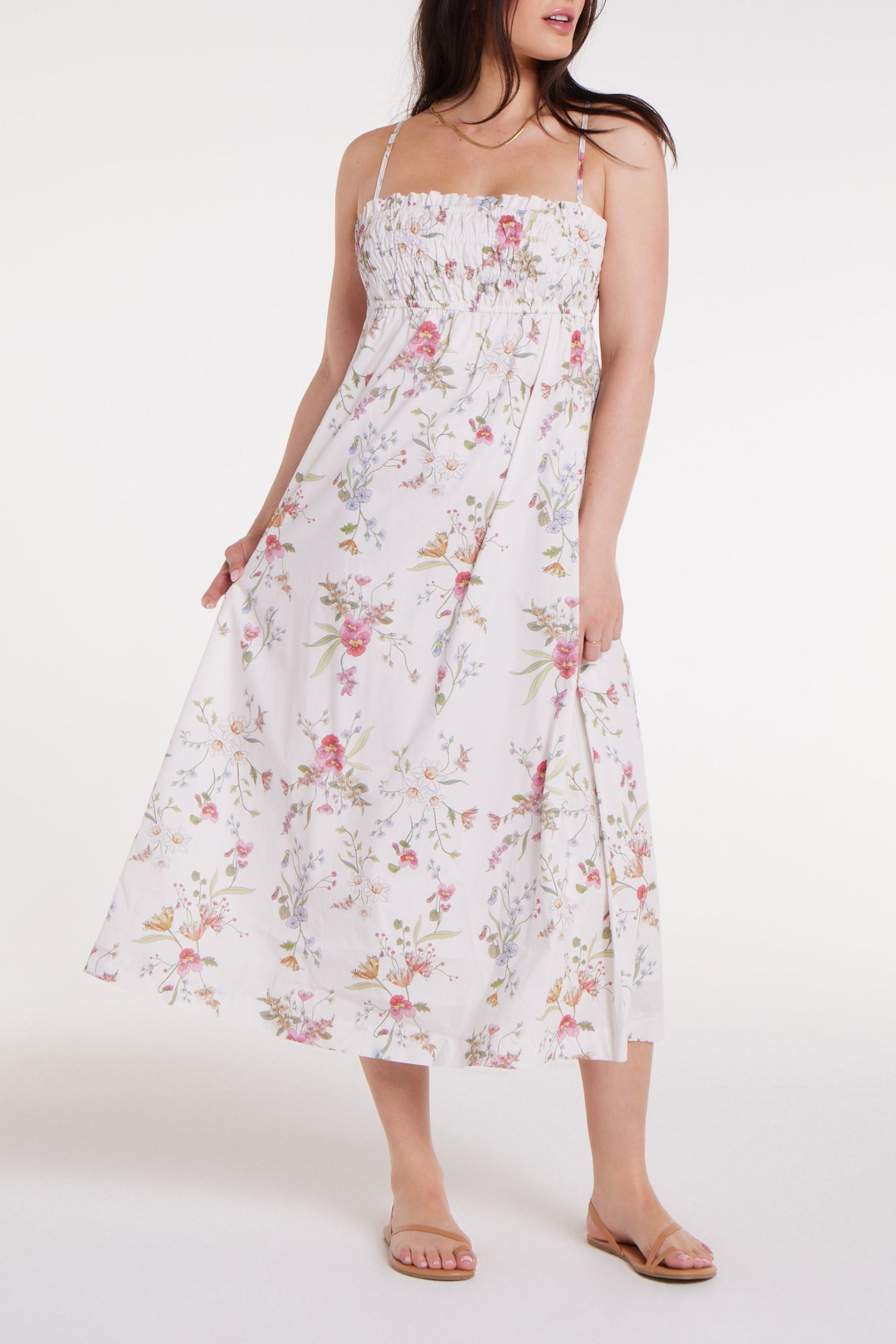 Woman wearing a floral dress on a white background