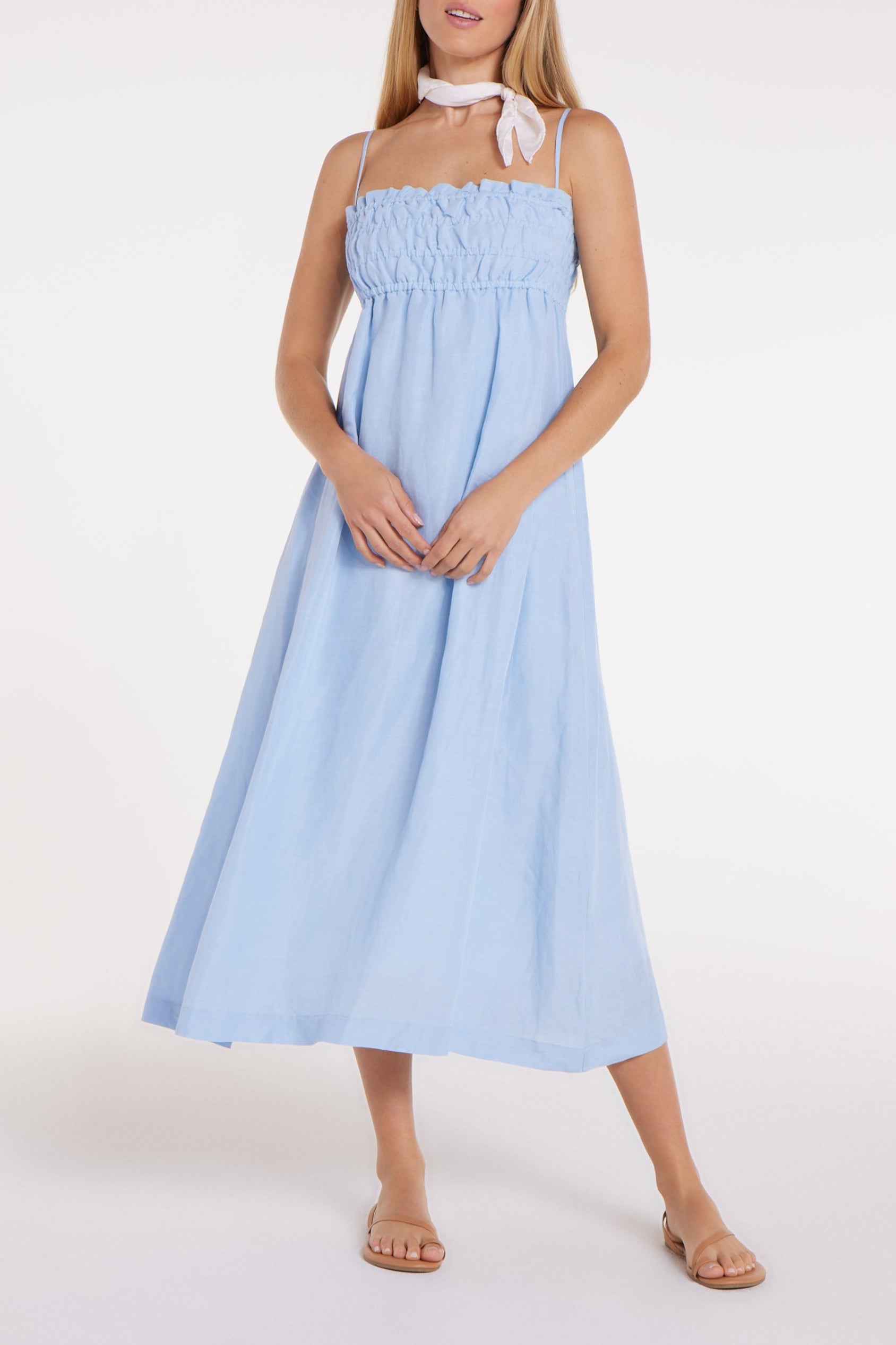 Woman wearing a light blue dress on a white background