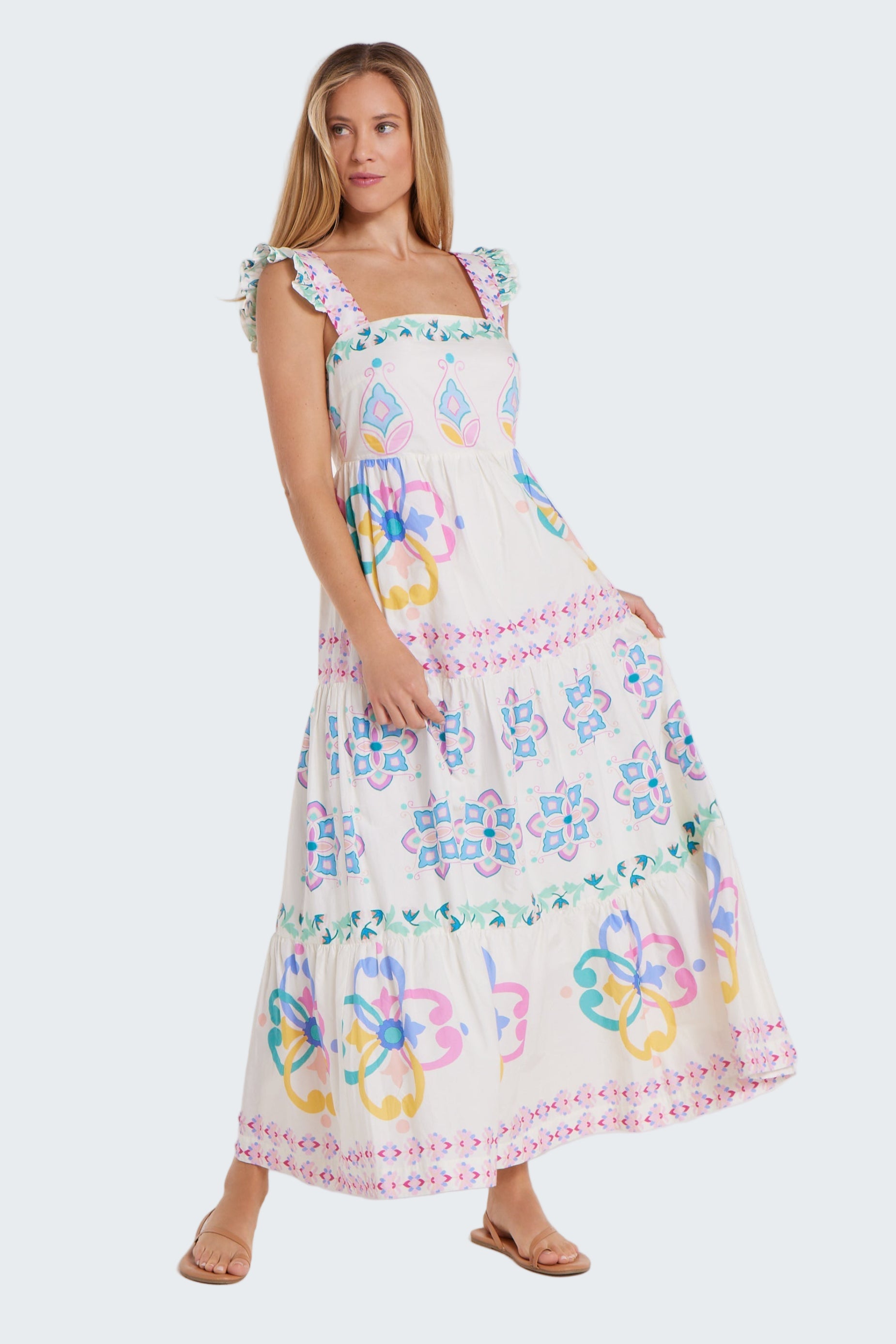 Woman wearing a colorful floral dress on a white background