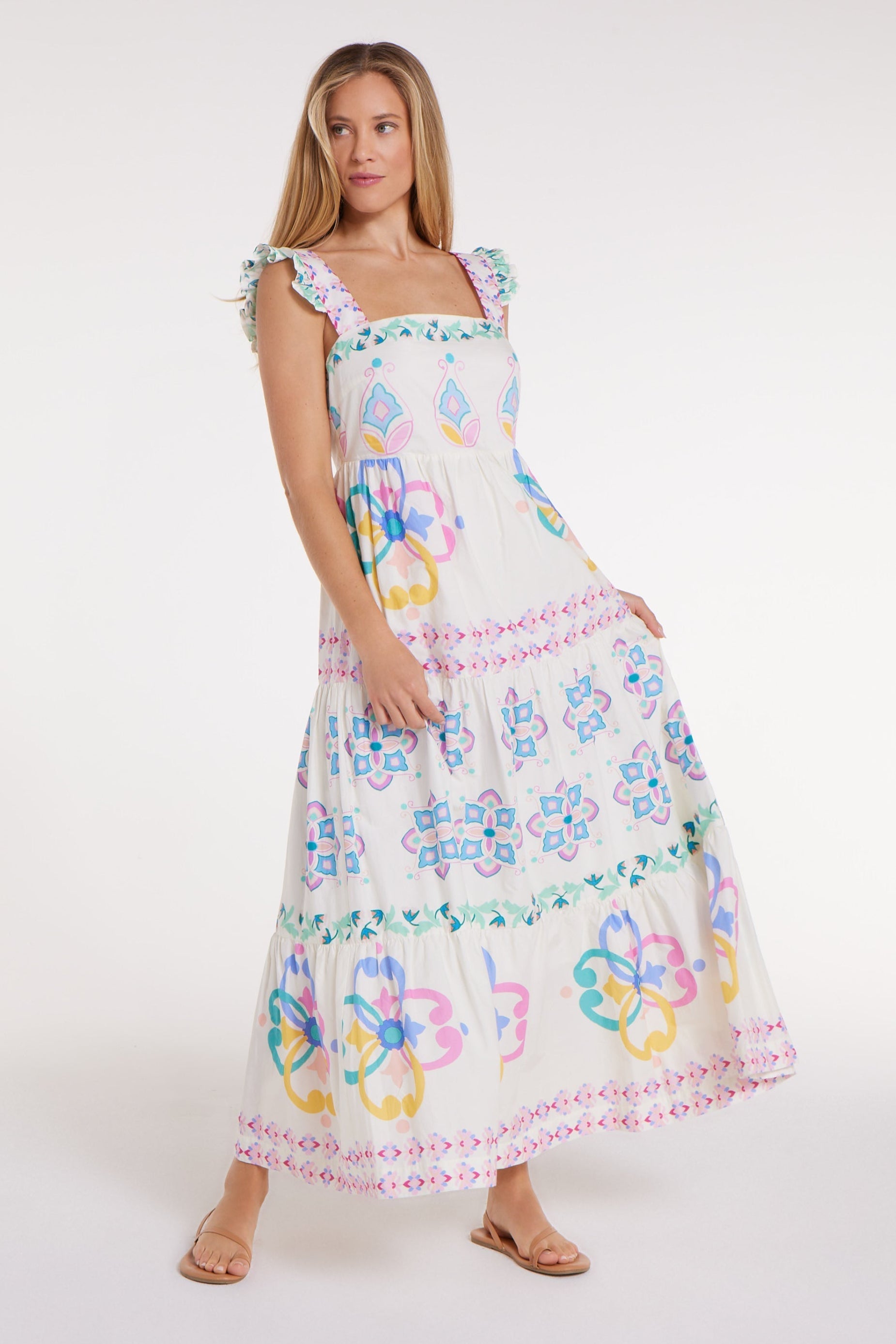 Woman wearing a colorful floral dress on a white background