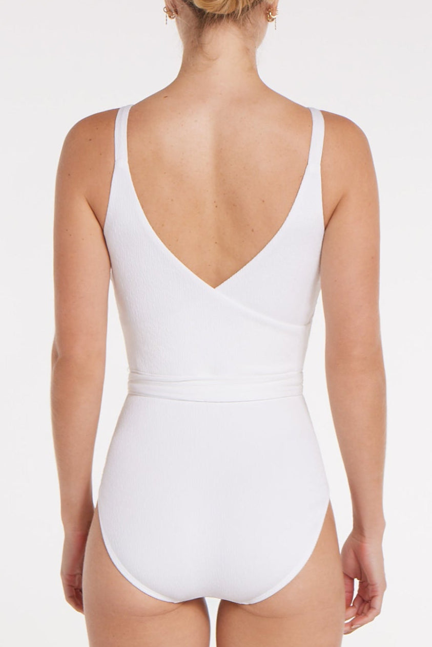 White swimsuit worn by a person on a white background