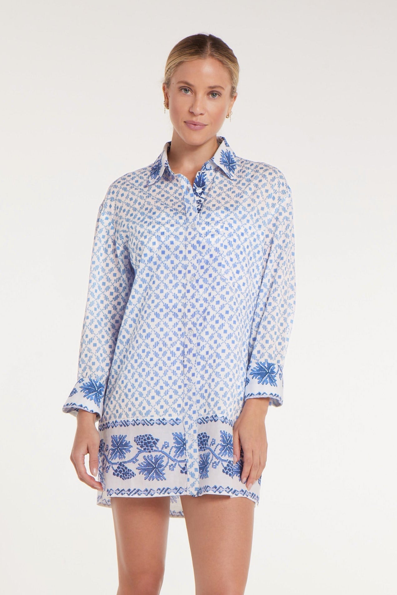 Woman wearing a blue and white patterned dress on a white background