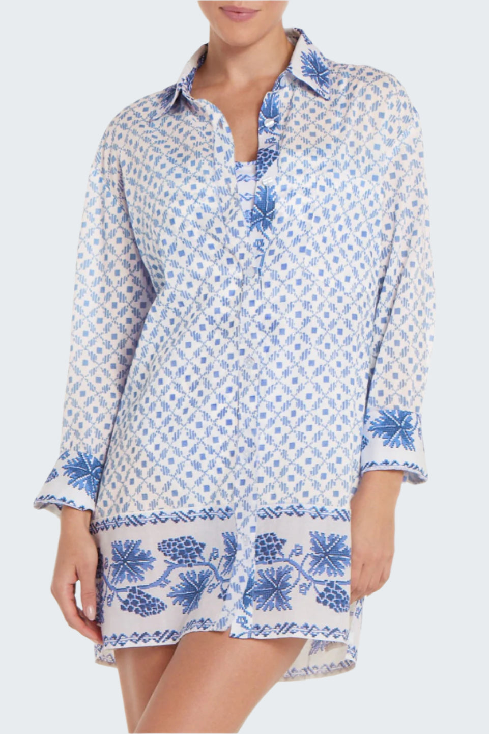 Woman wearing a blue and white patterned shirt dress on a white background