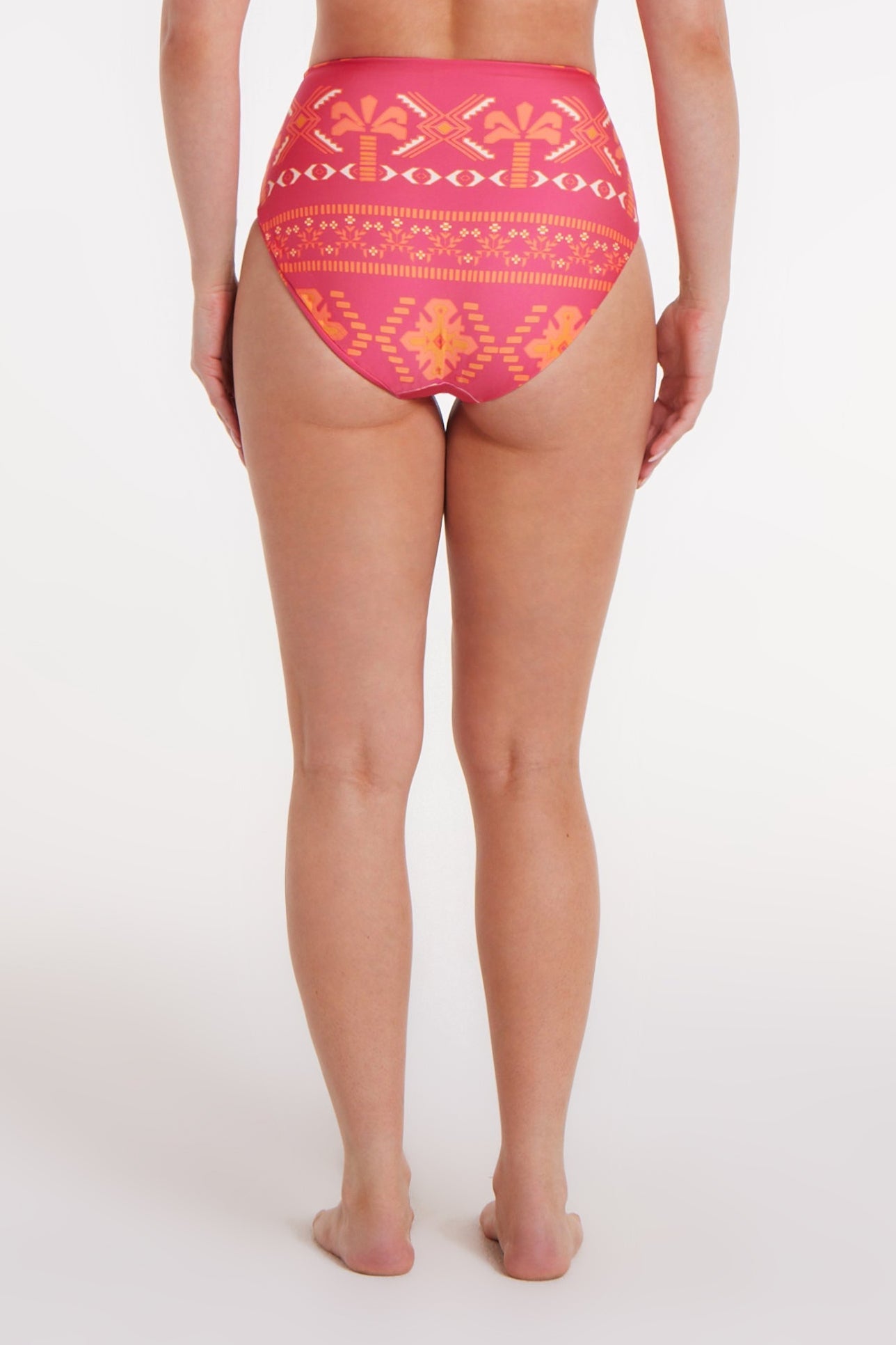 Person wearing pink patterned underwear on a white background