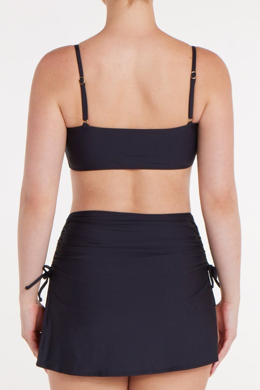 Person wearing a black bikini set on a white background