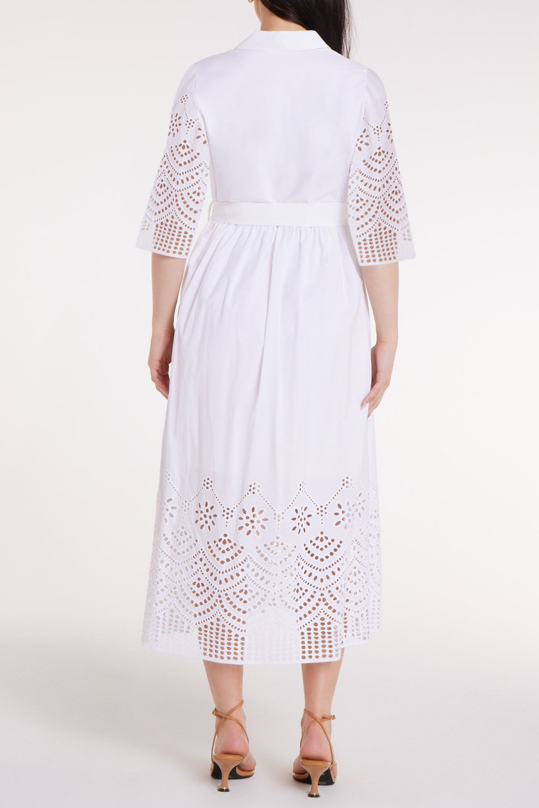 White dress with lace details on a white background