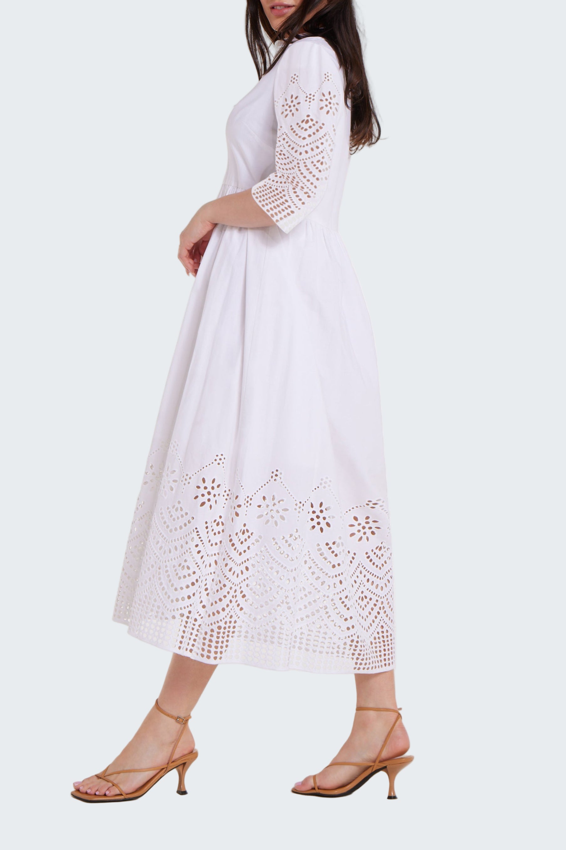 White lace dress worn by a model on a white background