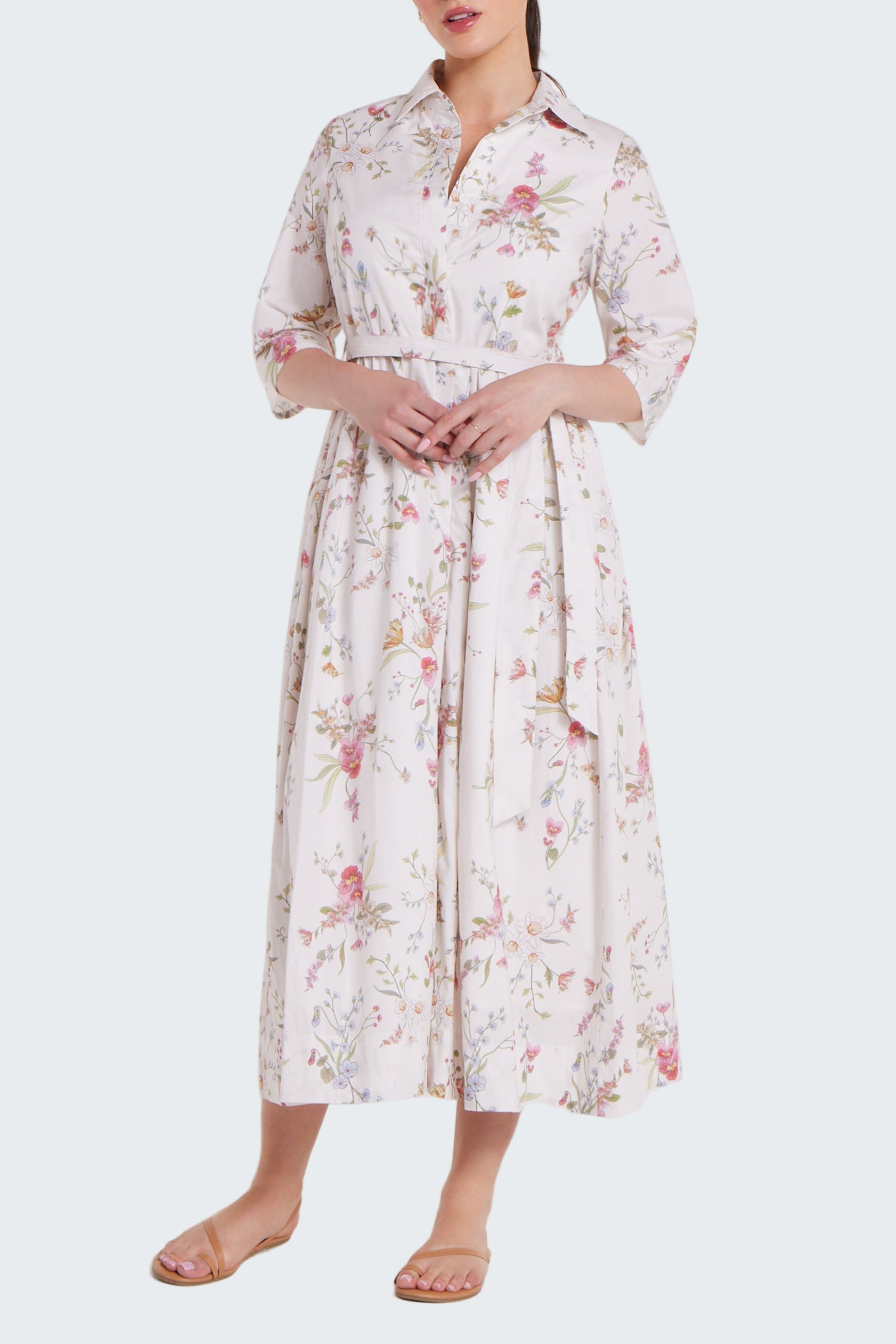 Woman wearing a floral dress on a white background