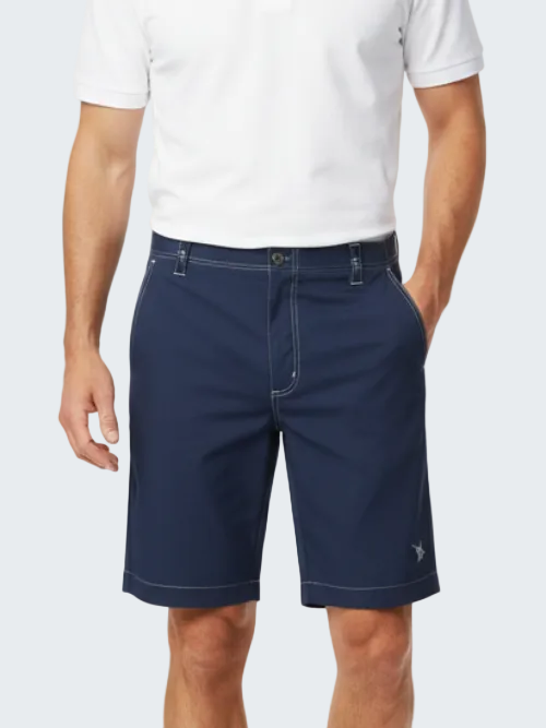 Man wearing navy shorts and a white shirt on a white background
