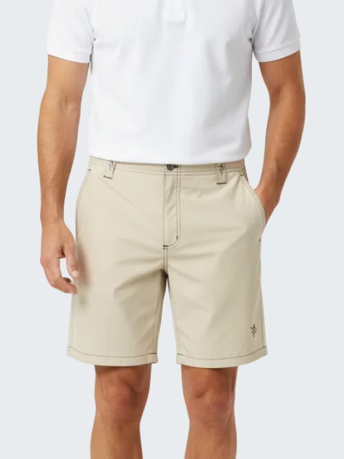 Beige shorts worn by a person on a white background