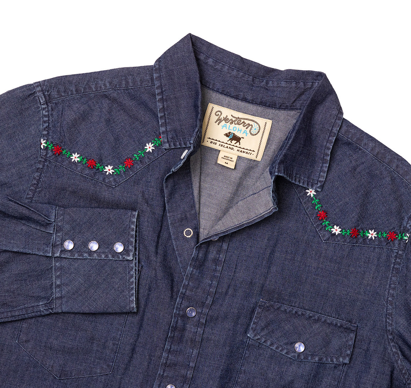 Denim shirt with embroidered details and a brand tag on a white background