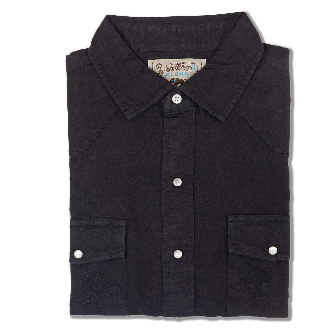 Folded black shirt with button details on a white background