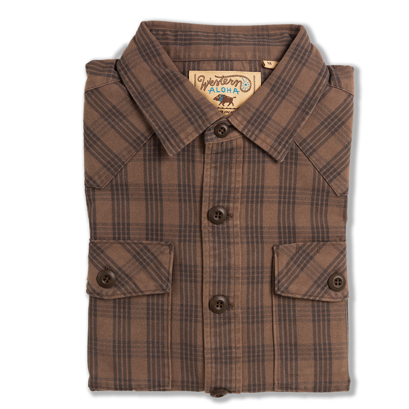 Folded brown plaid shirt with a visible brand label on a white background