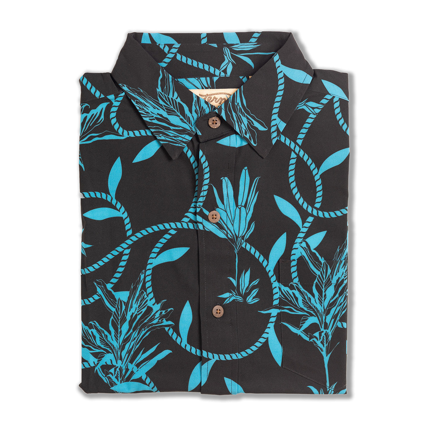 Folded black shirt with blue rope and leaf pattern on a white background