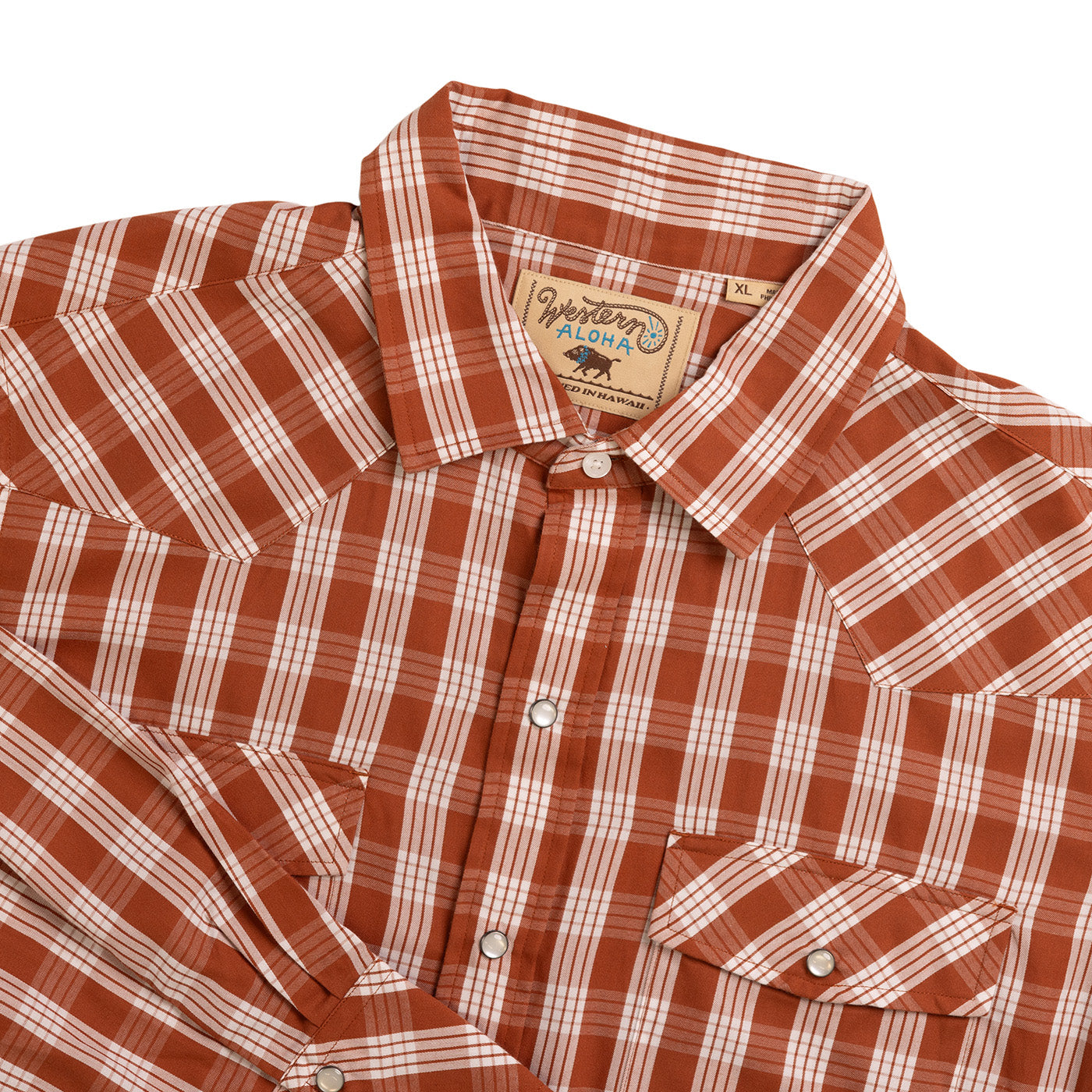 Brown and white plaid shirt with a brand label on a white background