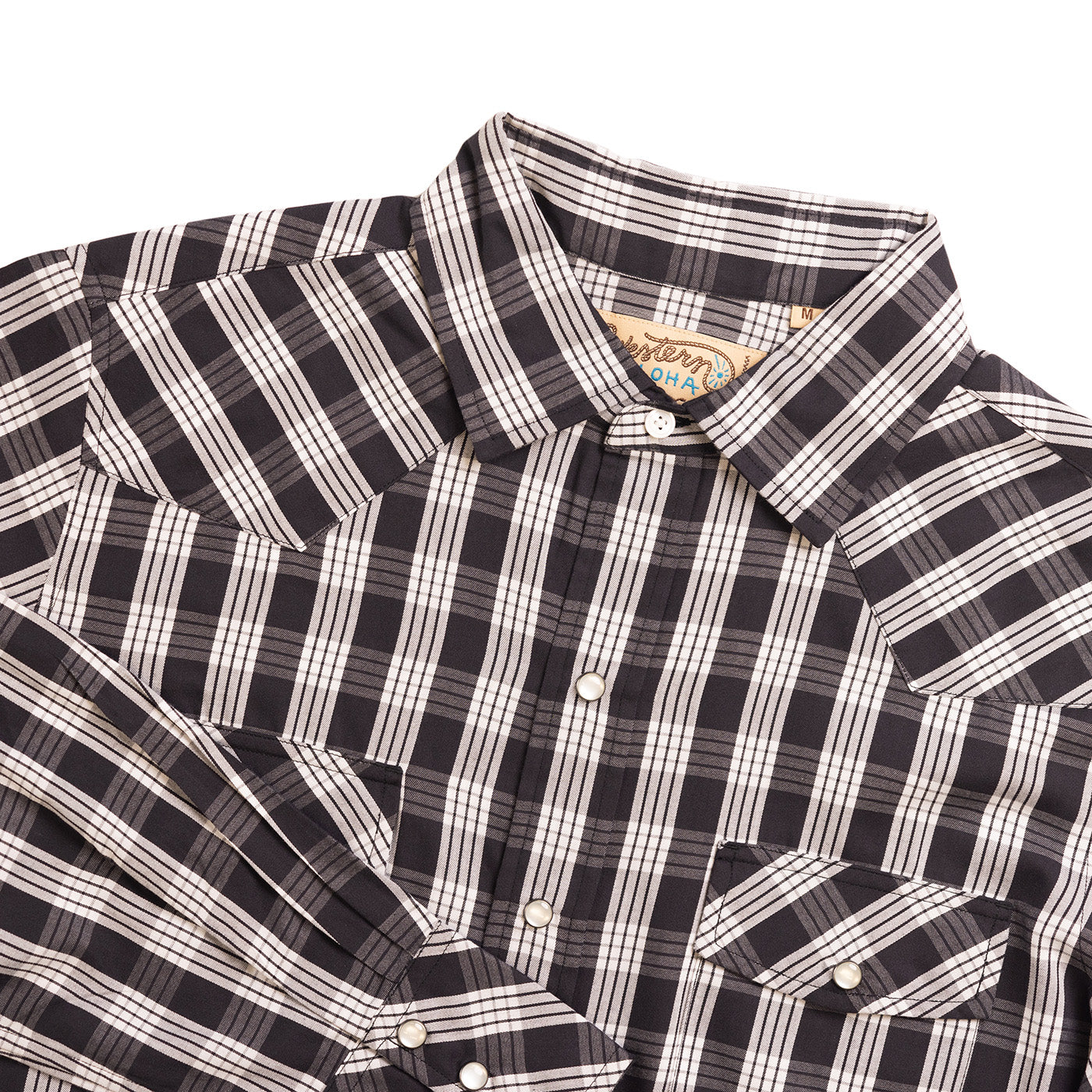 Black and white plaid shirt with a brand label on a white background