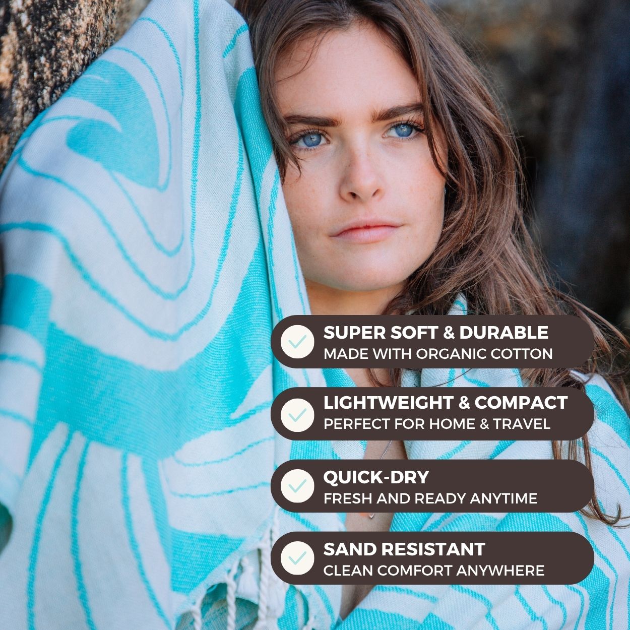 Woman wrapped in a blue and white patterned towel with product features displayed.