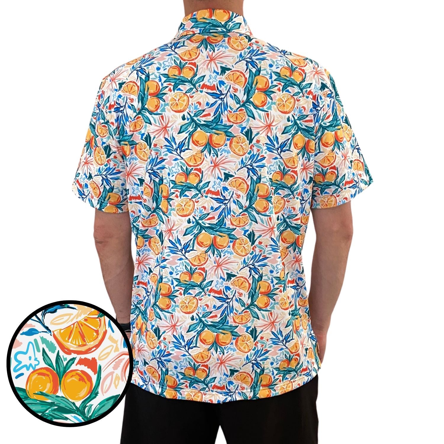 Colorful shirt with fruit pattern worn by a person on a white background