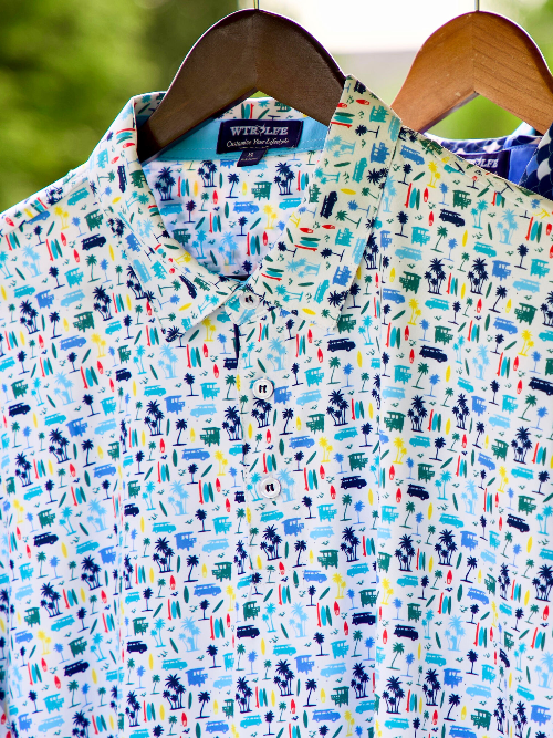 Colorful patterned shirt on a hanger with a blurred green background