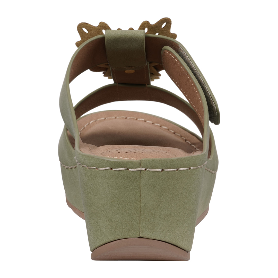 Green sandal with a wedge heel on a white background