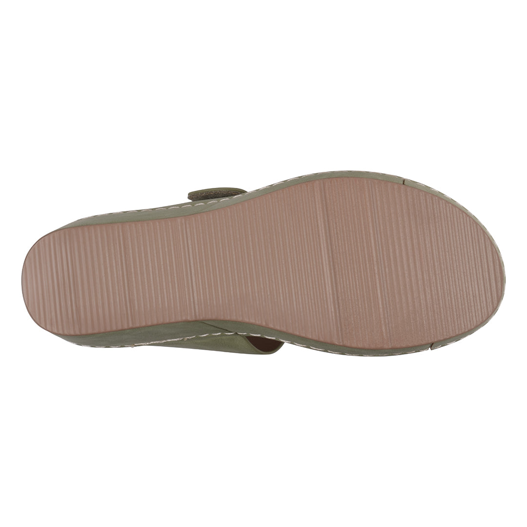 Bottom view of a sandal with a textured sole on a white background