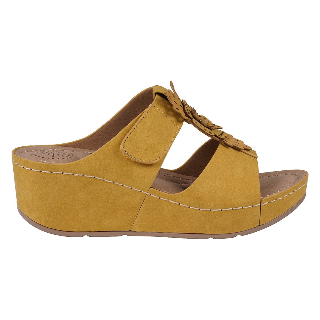 Yellow sandal with a wedge heel on a white background