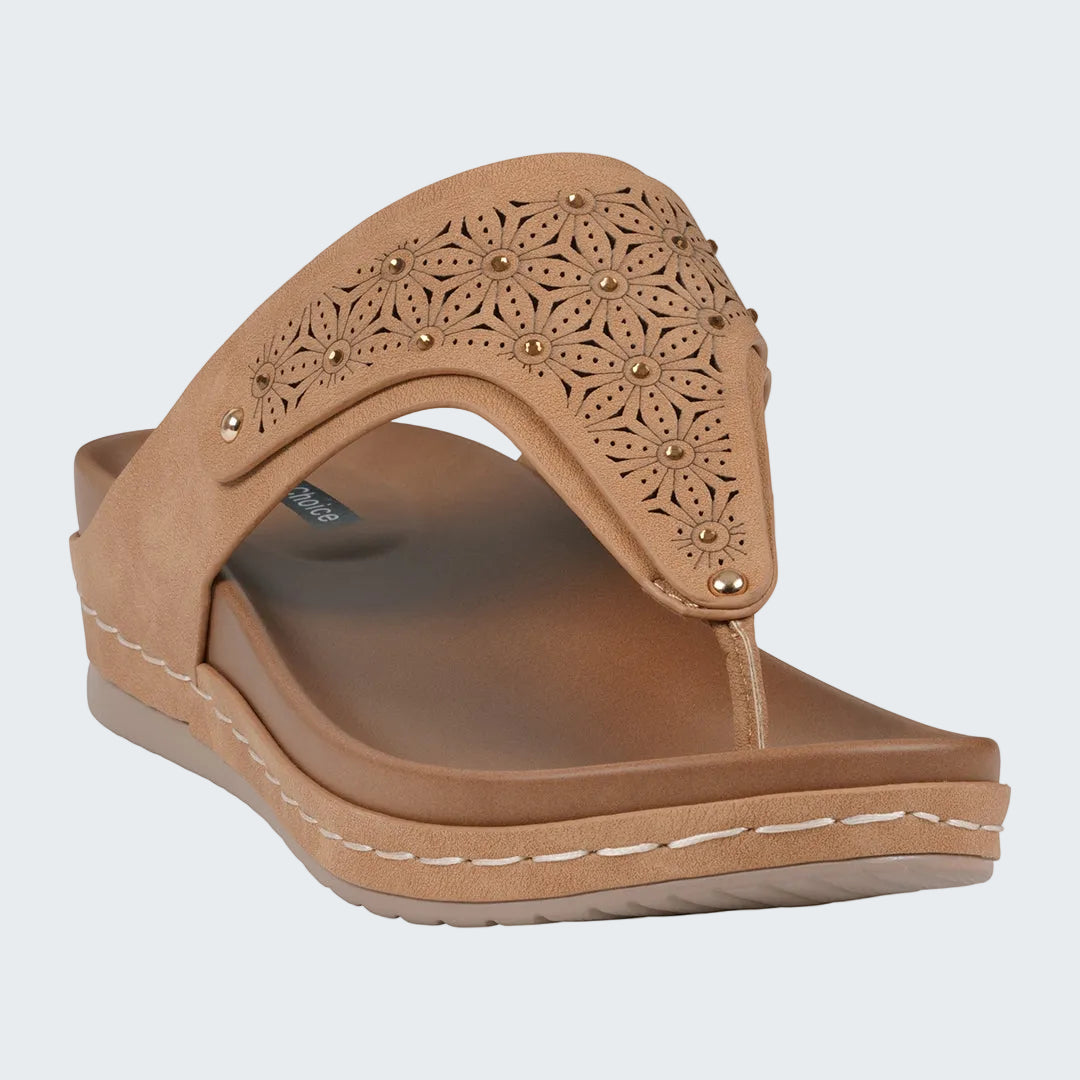 Tan sandal with decorative straps on a white background