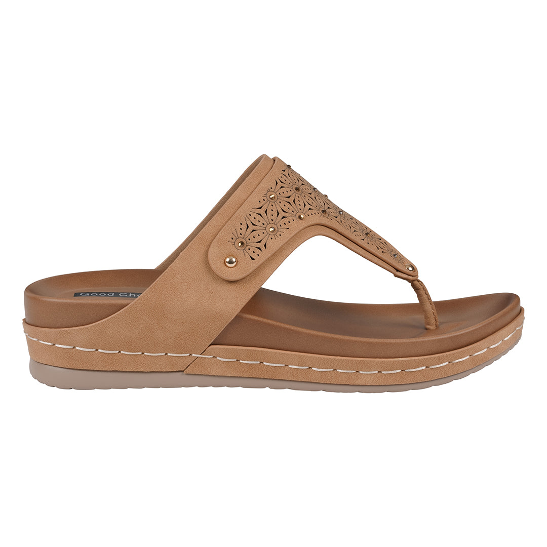 Tan sandal with decorative straps on a white background