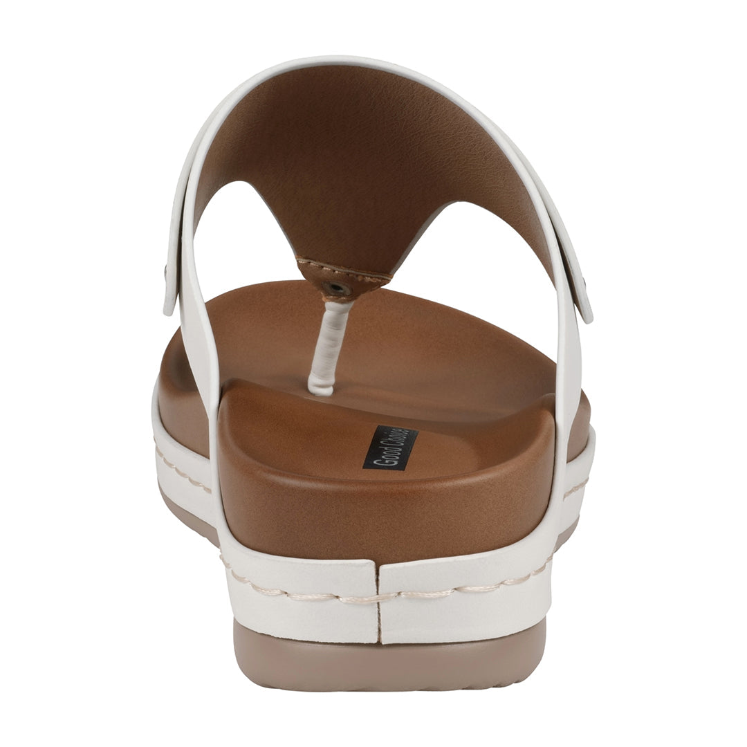 White sandal with brown sole on a white background