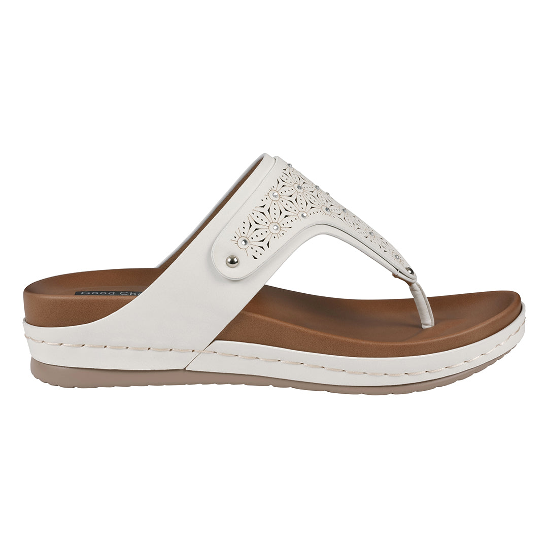 White sandal with brown sole on a white background