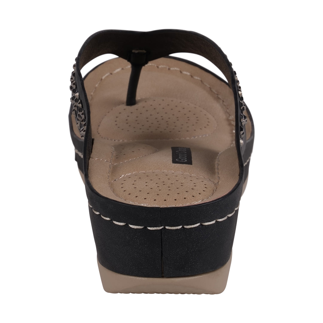 Black wedge sandal with tan insole on a white background