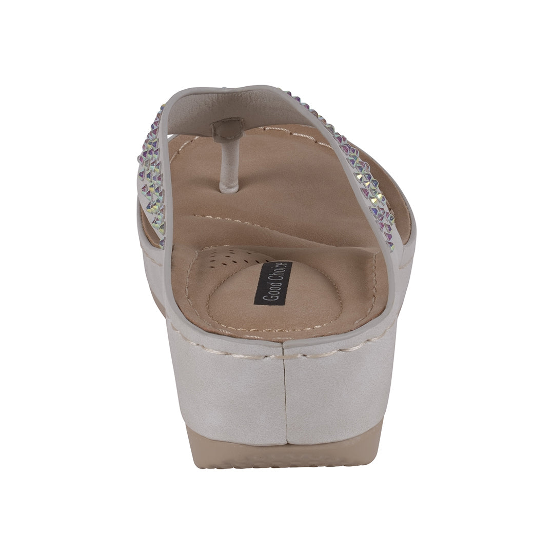 White sandal with rhinestone embellishments on a white background
