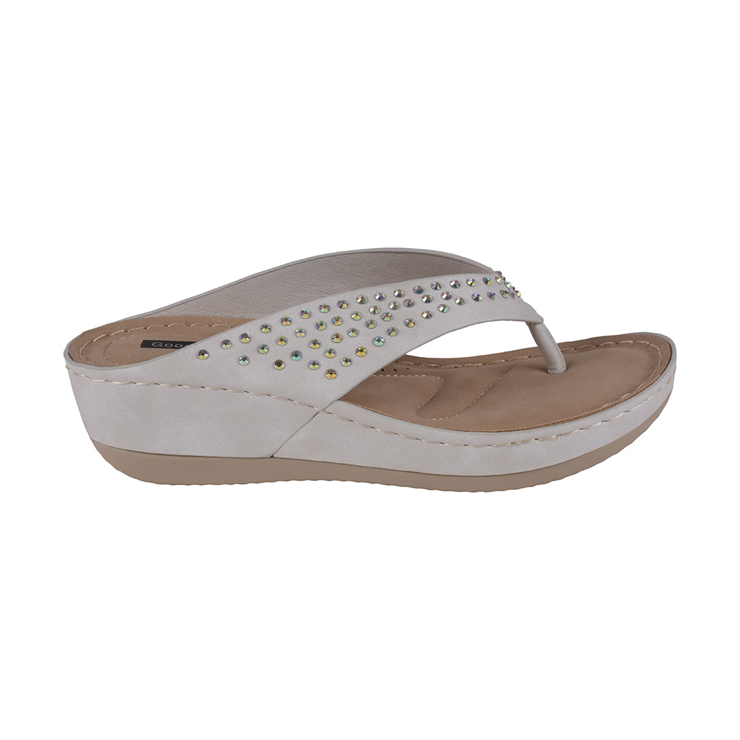 White sandal with rhinestone embellishments on a white background
