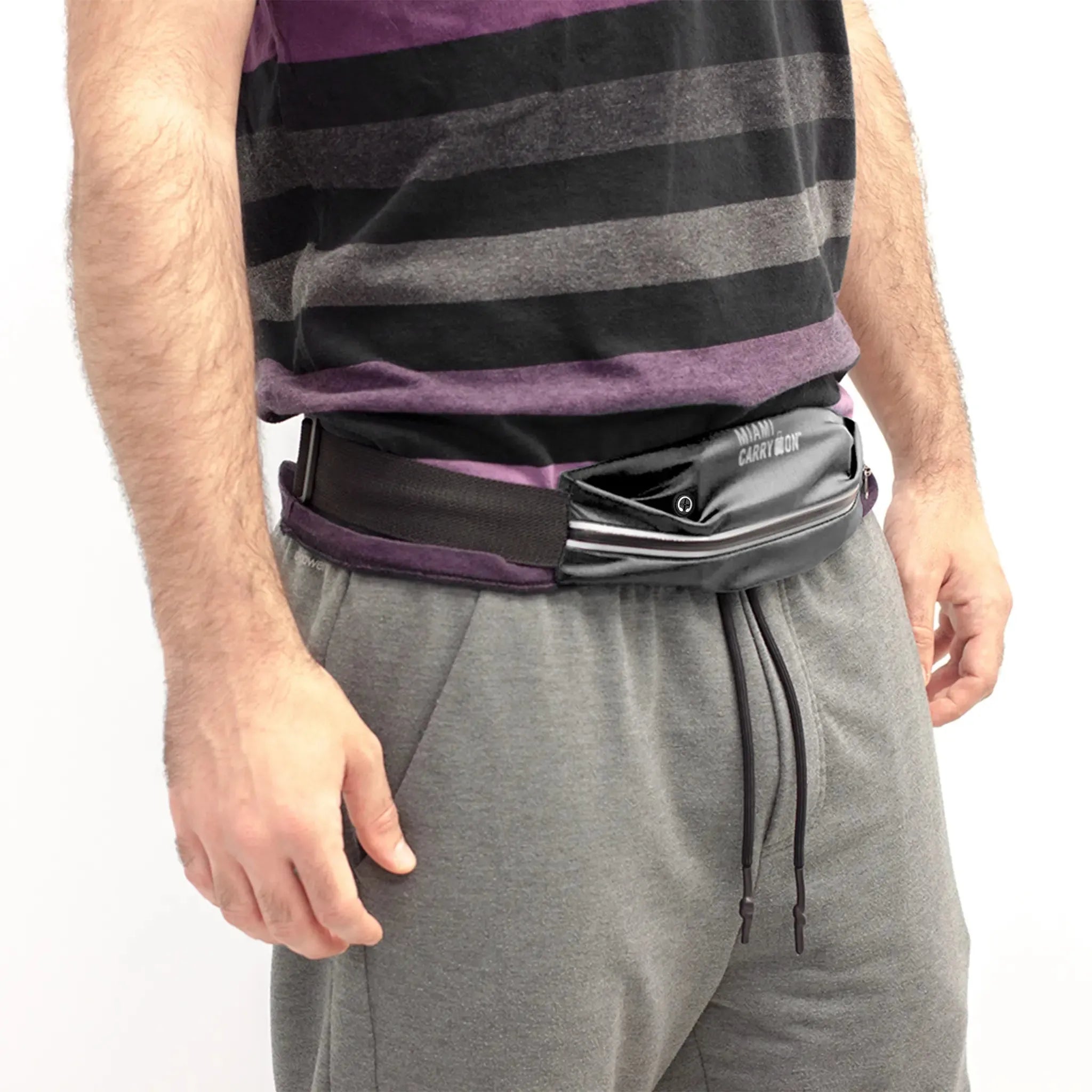 Person wearing a striped shirt and gray pants with a black waist bag on a white background