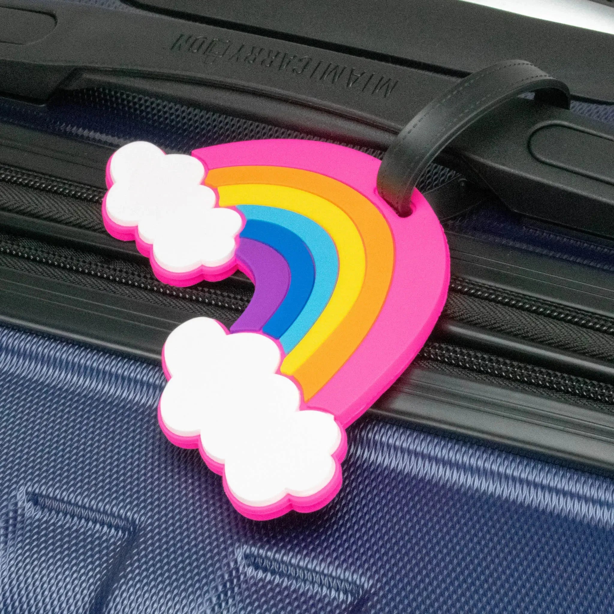 Colorful rainbow and cloud luggage tag attached to a blue suitcase.