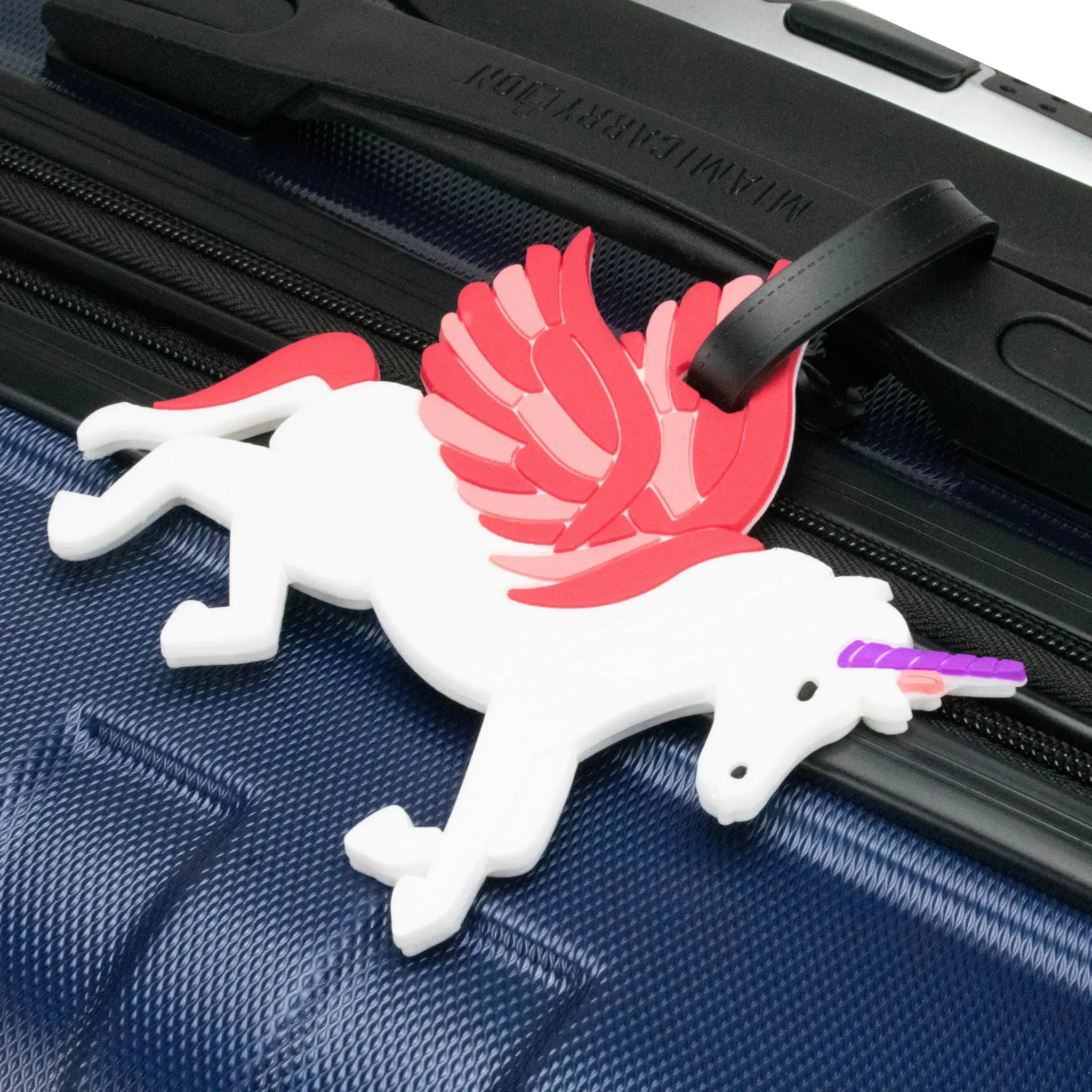 Unicorn-shaped luggage tag on a suitcase
