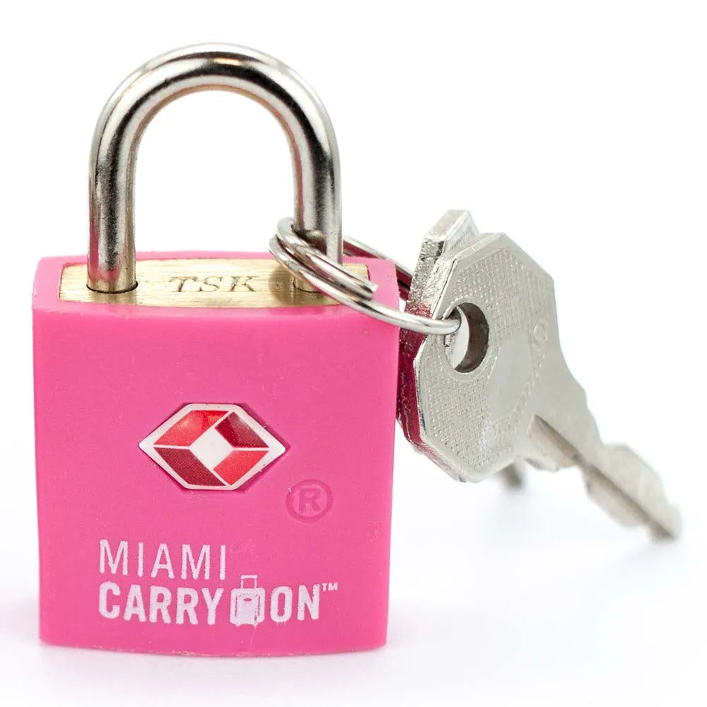 Pink travel lock with key on a white background