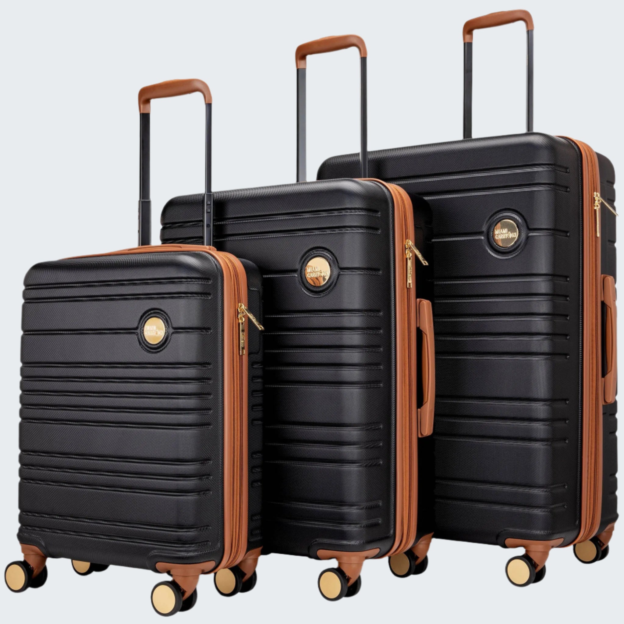 A set of three black Brickell brand suitcases with brown accents, displayed in a nested arrangement with the largest at the bottom and the smallest at the top, showcasing the expandable design.