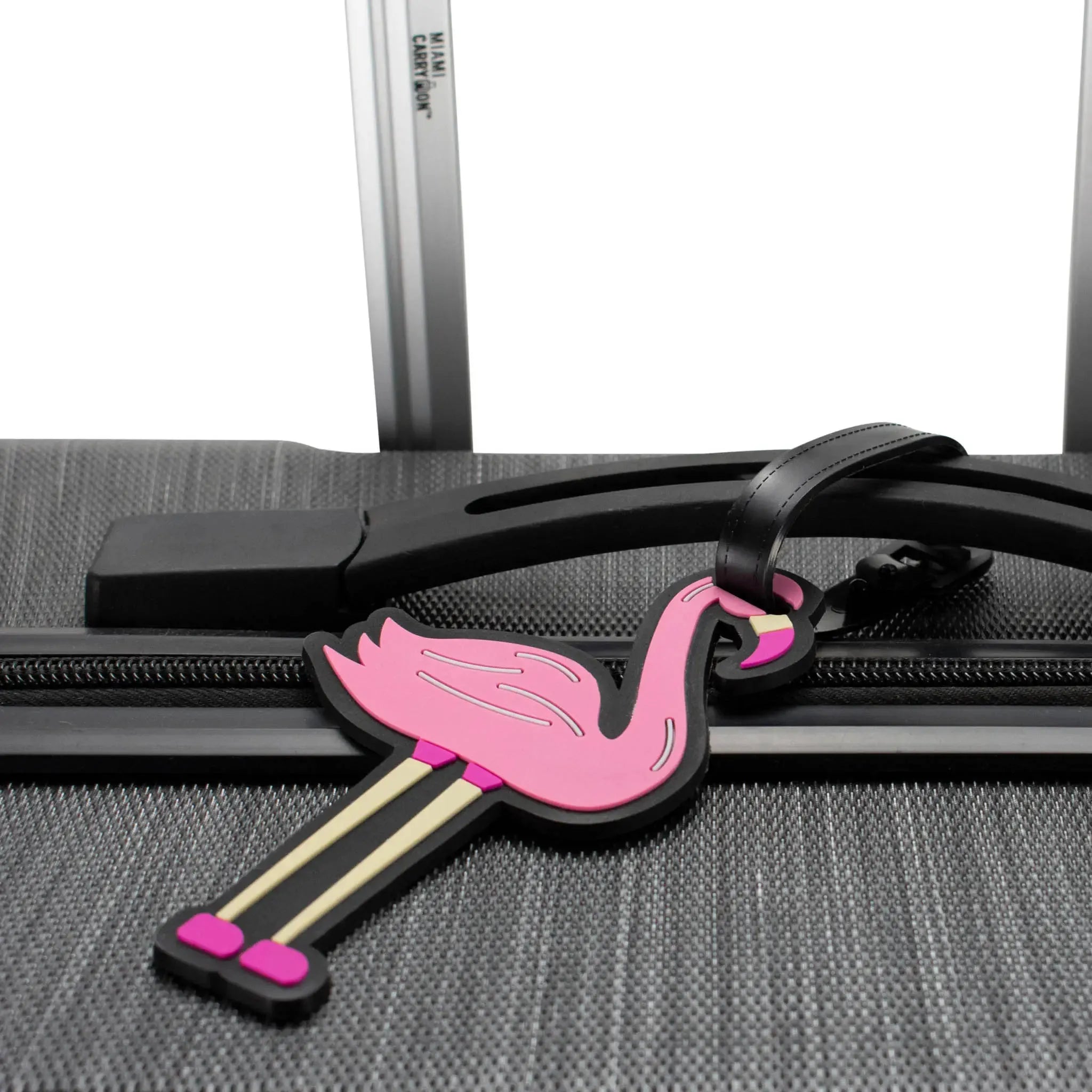 Flamingo-shaped luggage tag attached to a suitcase handle.