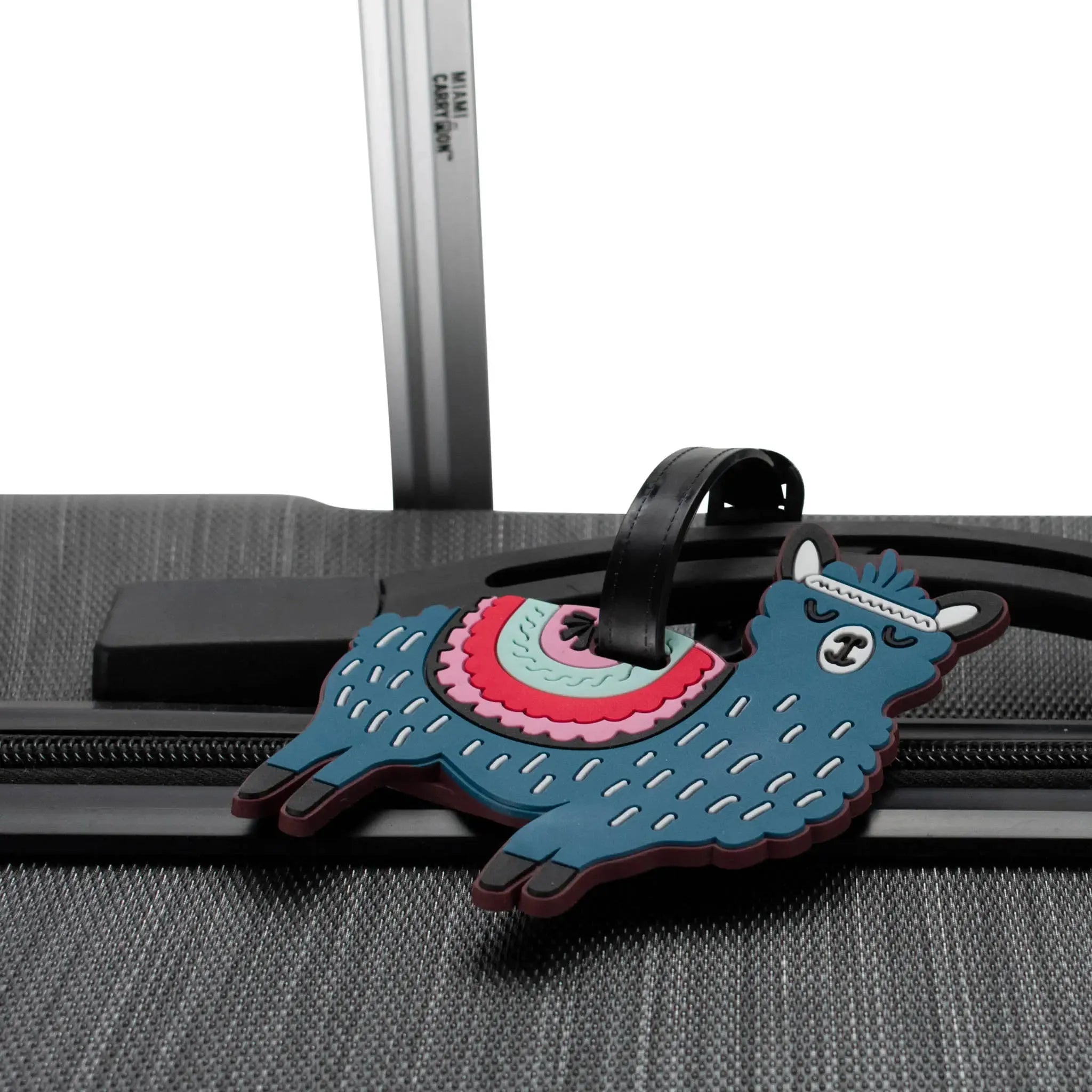 Llama-shaped luggage tag attached to a suitcase handle