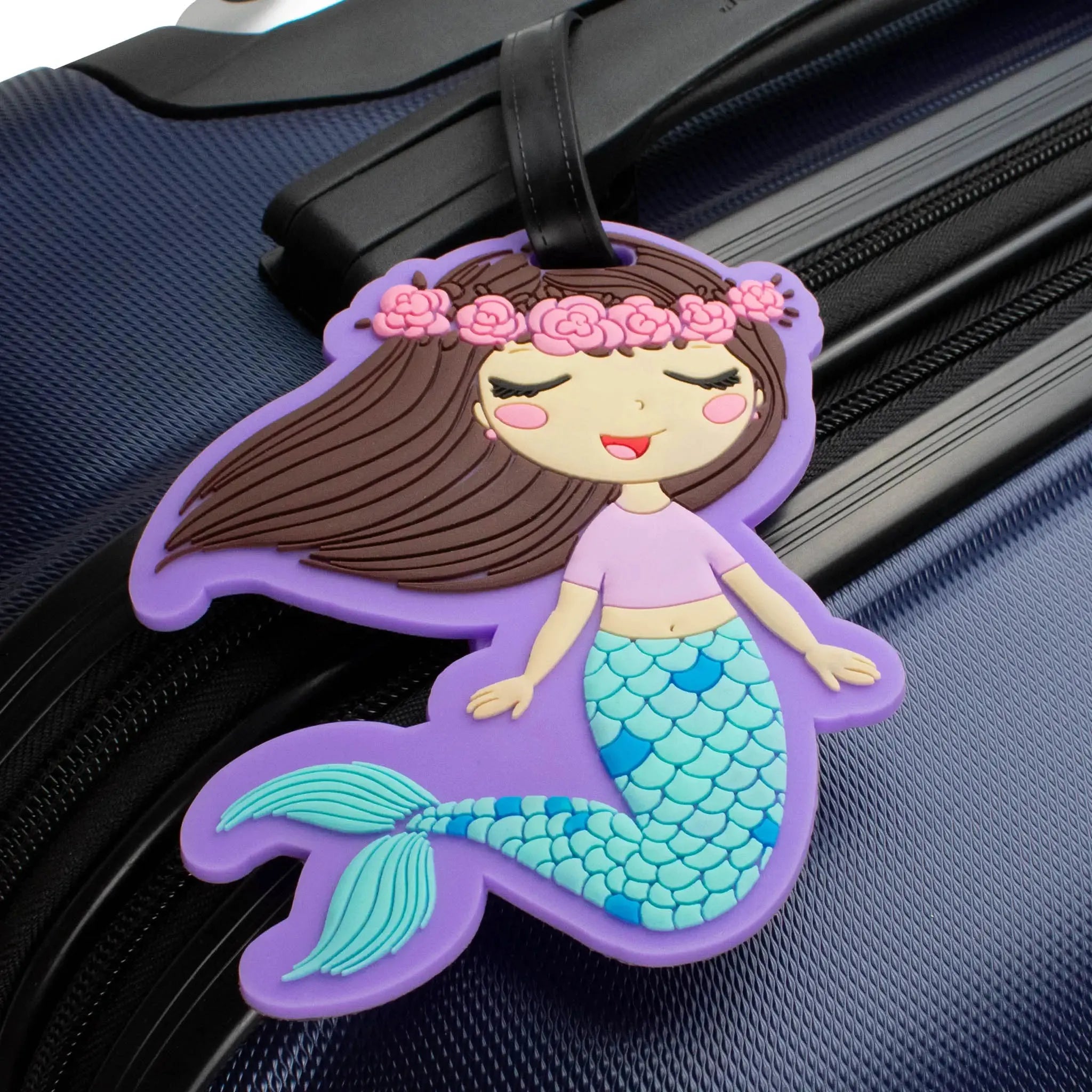 Mermaid-shaped luggage tag on a suitcase