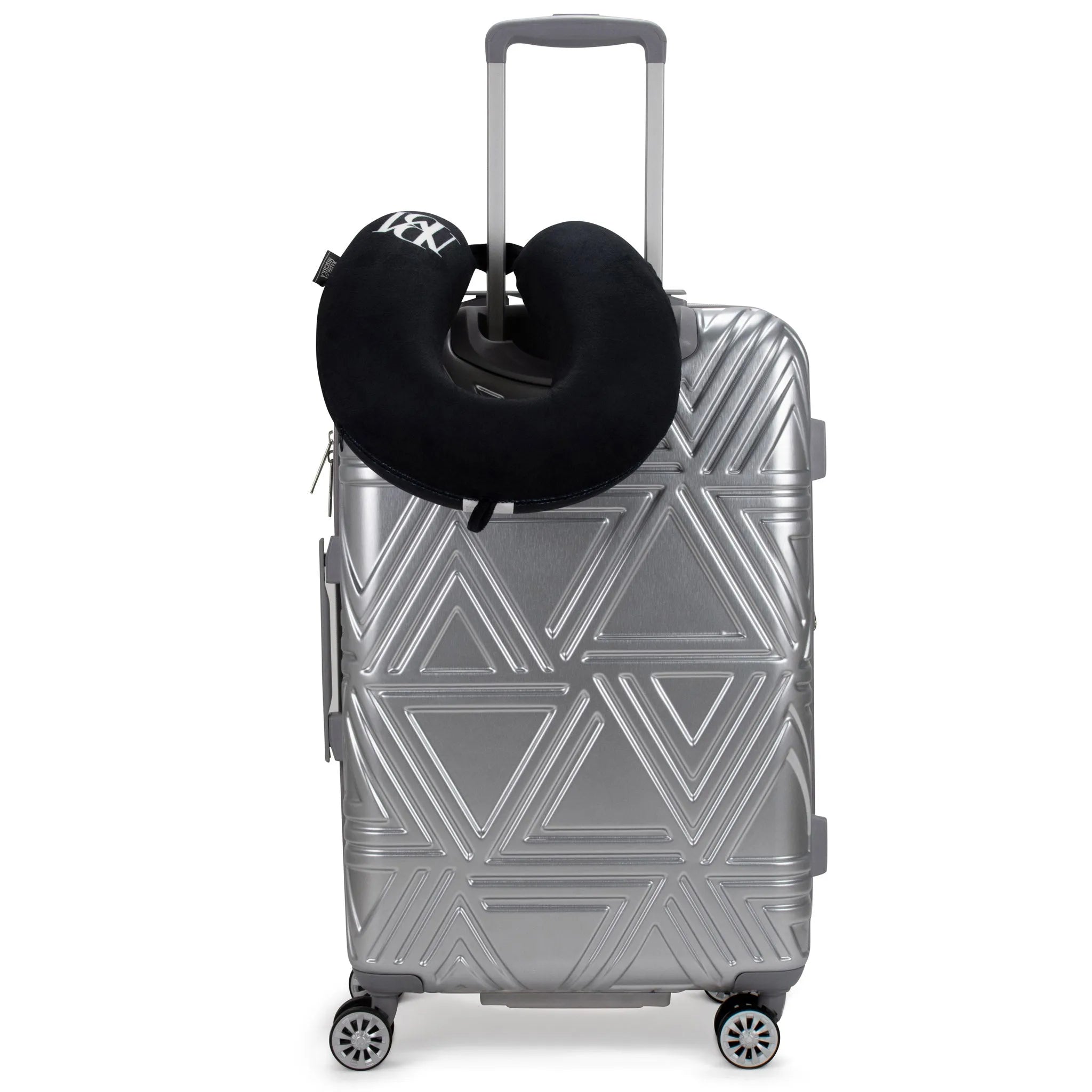 Silver geometric-patterned suitcase with a black neck pillow on a white background