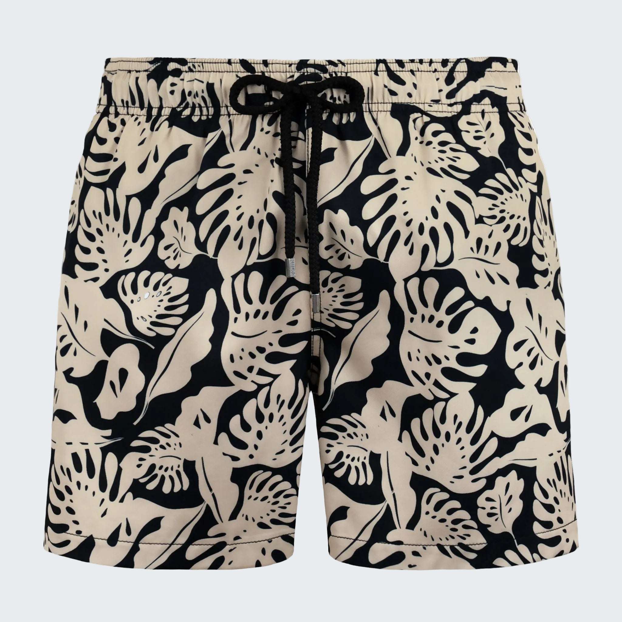 Beige and black floral patterned shorts on a white background