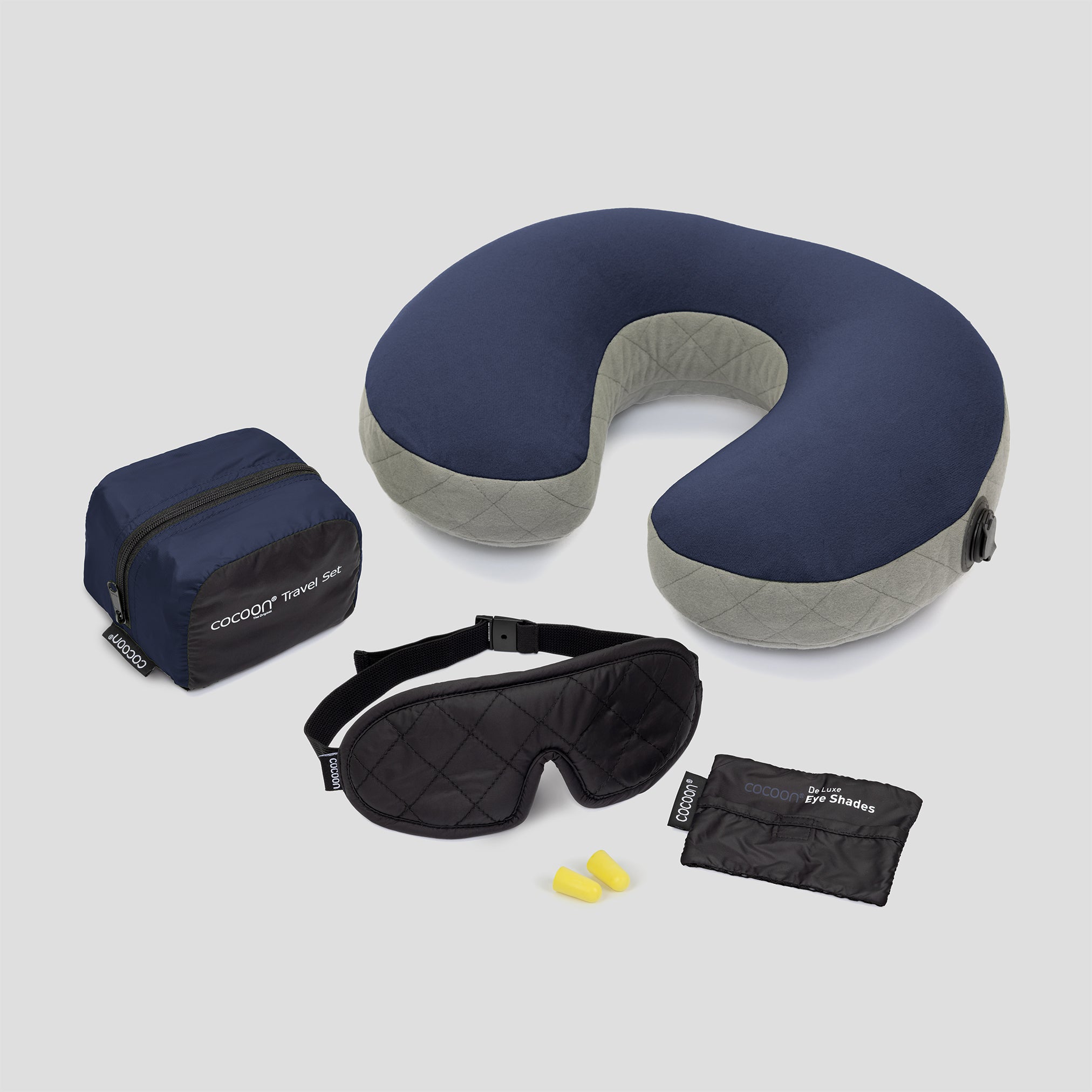 Travel pillow, eye mask, and pouches on a white background